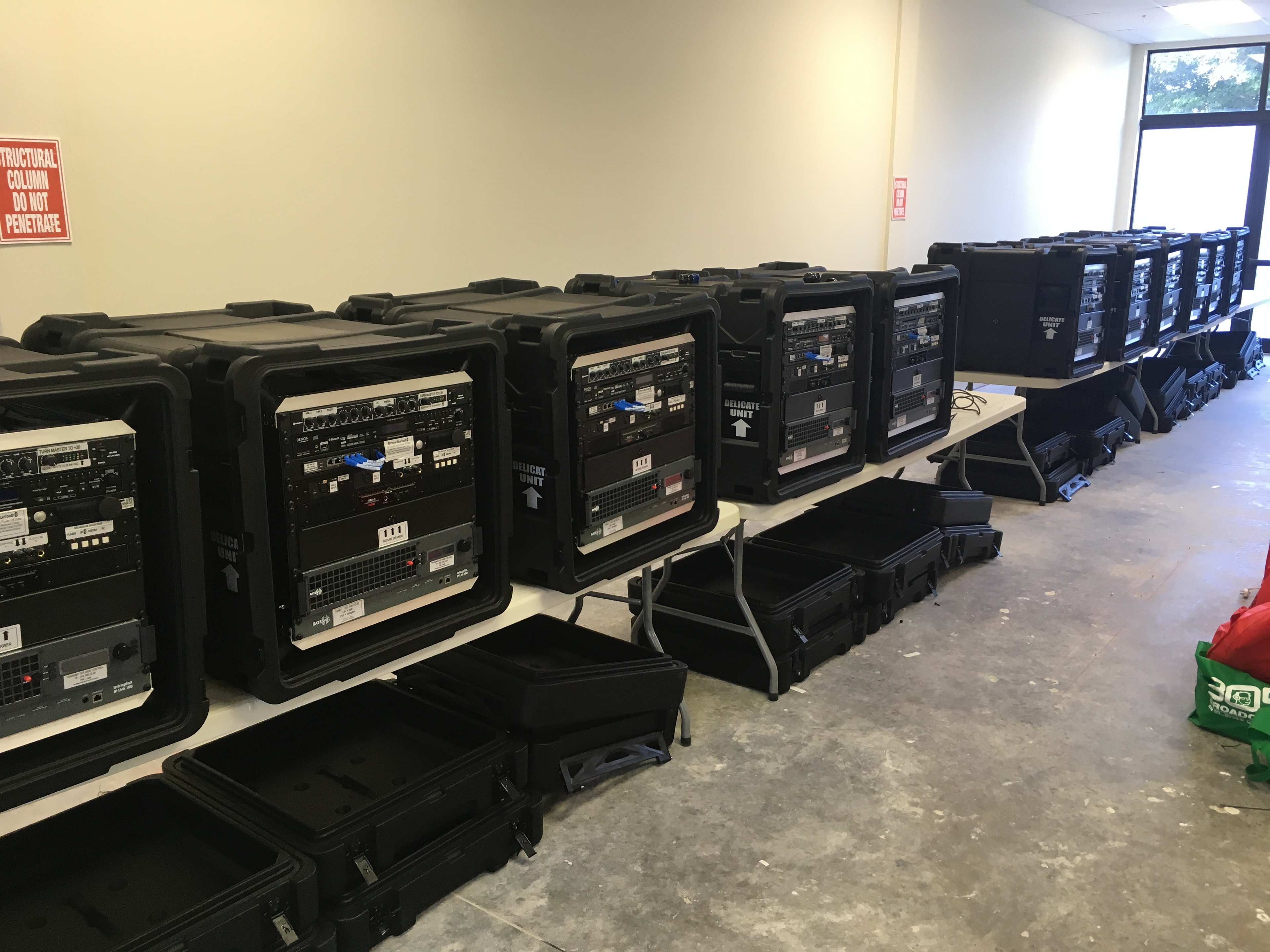 Kerberos RIAB portable FM broadcast systems staged for deployment — multiple radio-in-a-box units ready for field operations
