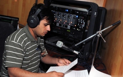 Local DJ operator at Kerberos RIAB broadcast console — Radio Unity, Logar Province
